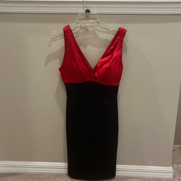 A black and red v-neck tighter fitted dress. It is pretty fancy. - Picture 1 of 3